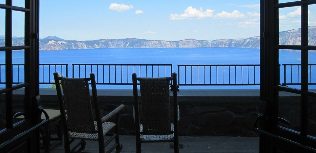 two chairs on a porch overlooking water