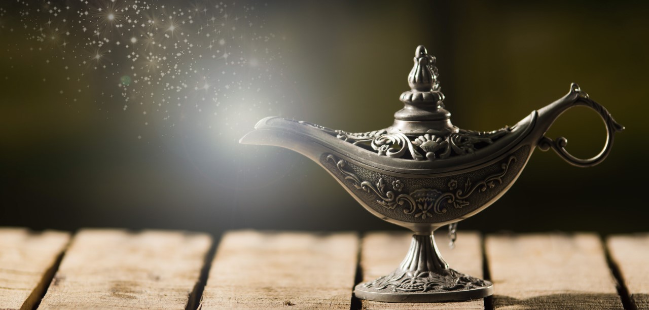 a genie lamp with magical light coming from the spout
