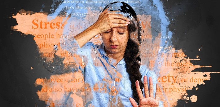 Stressed middle aged woman with hand on forehead